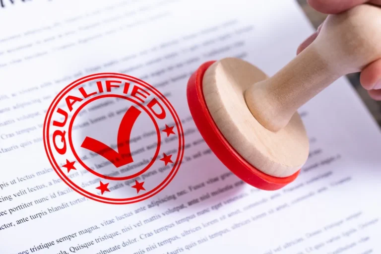 Rubber stamp with 'Qualified' mark on a document, symbolizing approval or certification